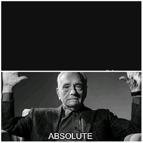 Older Person in Suit Raising Hands