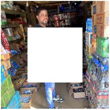 Person in Small Shop of Goods