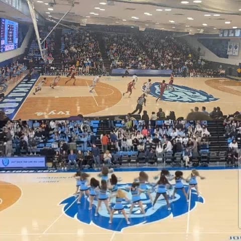 Basketball Game Action with Cheerleaders