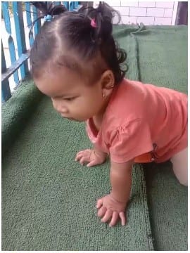 Crawling Child on Green Carpet