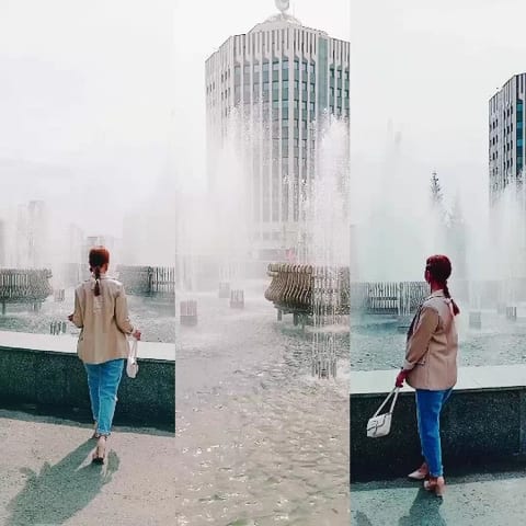 Person by Fountain with Building