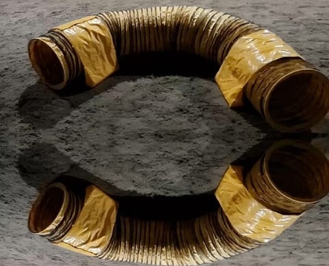 Coiled Yellow Duct on Rough Surface