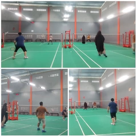 People Playing Badminton Indoors