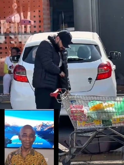 Man with Groceries by White Car