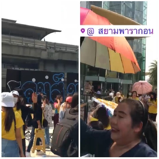 Group with Umbrellas in Urban Area