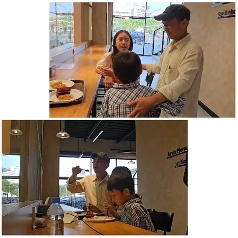 Man and Child Interacting in Cafe