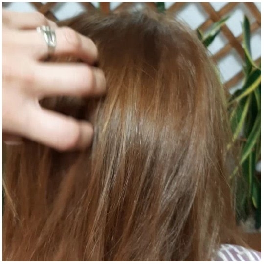 Hand Touching Hair in Nature