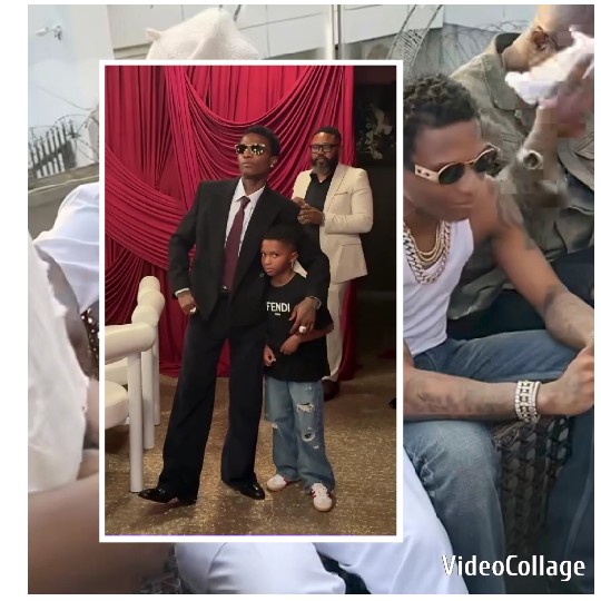 Man in Suit with Child by Curtain