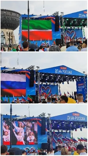Crowd at Outdoor Event with Stage