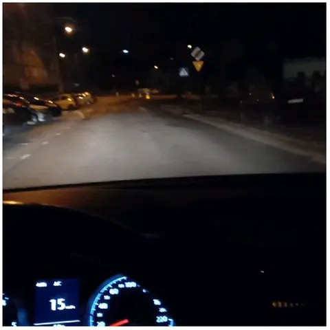 Nighttime Car View with Street Lights