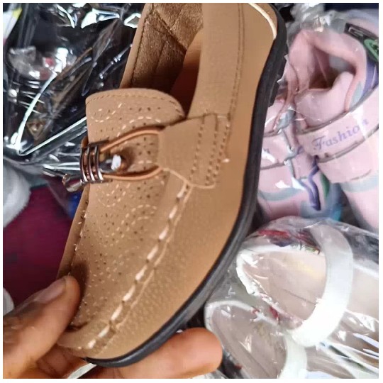 Hand Holding Brown Shoe for Sale