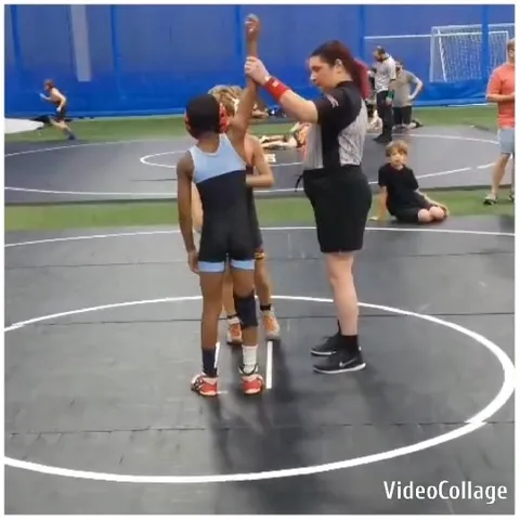 Referee Signals Victory for Wrestler