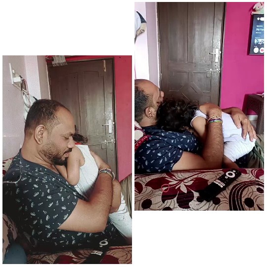 Man Comforts Child on Sofa