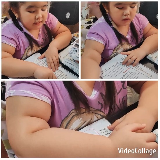 Child Focused on Papers at Desk