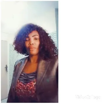 Curly-Haired Person Indoors in Jacket