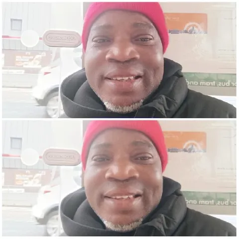 Man in Red Beanie Smiling Outdoors