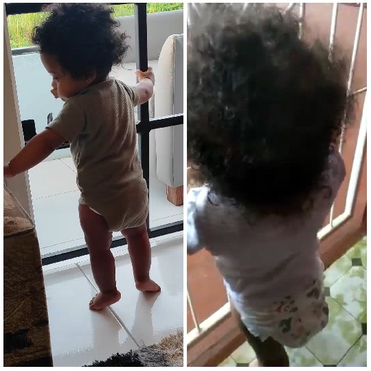 Child Standing by Door and Railing